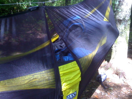 This hooks onto an included line that you tie to both hammock straps or directly to the trees you use.