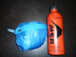 Jacket packed in own pocket with 22oz MSR fuel bottle for comparison