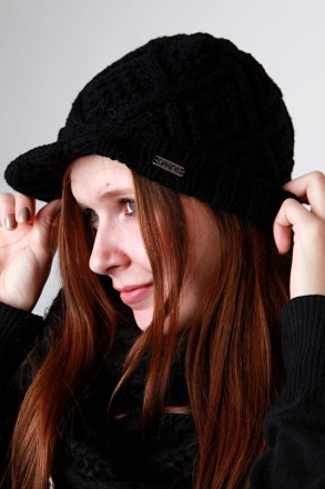 This is a pretty low-profile beanie.  Definitely no extra material on top like many slouch fit beanies have now.  Hopefully this picture of the beanie on a person will help give you an idea of the fit: