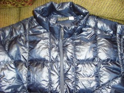 Collar, logo, zipper, zipper garage, and shell fabric detail.