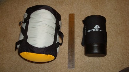 I have the Sea to Summit eVent compression sack <br/> (http://www.backcountry.com/sea-to-summit-event-compression-dry-sack), size small 10L, and my Arroyo regular fits in there with about 5" room left in the sack, definitely enough to fit the long Arroyo too. The regular should also fit fine in the XS, or if you want to play it safe, just go with 2 smalls. <br/>  <br/> Picture is the regular Arroyo inside the small seaToSummit eVent.