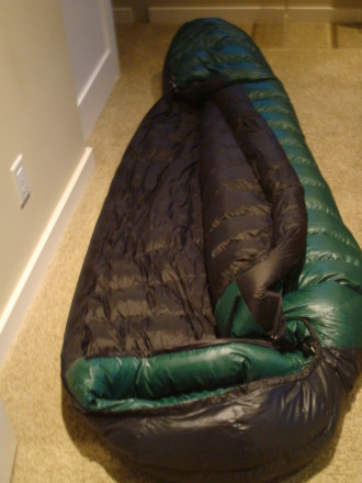 In this picture (not a Marmot though), you'll see the draft tube. It's the long, black insulated tube that runs down the length of the zipper. In the foreground, you'll also see the green draft collar that insulates around your neck between the hood and the body of the bag. Both are important features to look for in quality mummy bag construction.