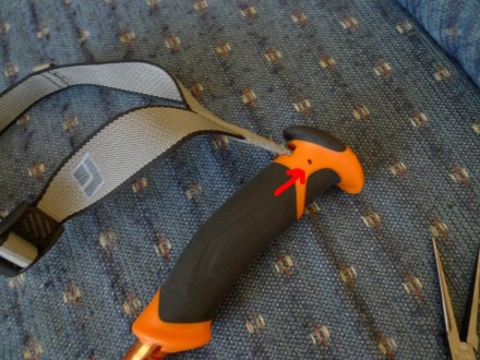 There's a metal pin holding the straps in place.  Use something long and skinny to push on one side of the pin and push it out the other side, then use pliers to pull it the rest of the way out from the opposite side.