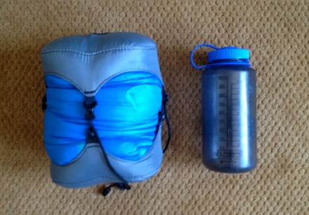 I was curious about your question so I tried it myself.  I packed the Helium into a Granite Gear size XS compression sack and cranked it down to 8" tall and 6.5" across.  Pretty small, as you can see from the photo that compares the compressed bag to a Nalgene.  Hope this helps!