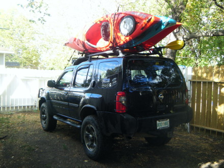 Hi, I have a 2002 Xterra and have had the Bigstack for a few years now, i'm very happy with it, i also bought the multi mounts for carring paddles. I already had a set of Yakima towers and crossbars, so i didn't have to figure out if it fit the factory rack, my only problem is i off road, so my X has a lift so need to take a folding stepladder to load my boats, lol   and when the Bigstack came out it was sold as being able to carry up to 4 boats, it does, i only take 3 because my cross bars aren't long enough